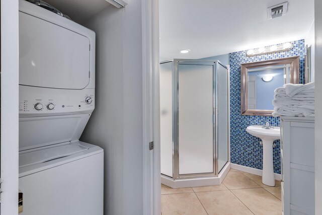 866 Santa Rosa Blvd Unit 302, Fort Walton Beach, FL 32548 - washroom featuring stacked washer / drying machine, tile patterned floors, and tile walls