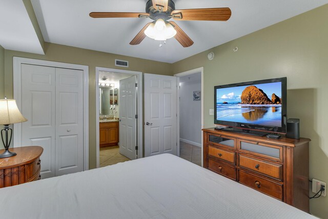 866 Santa Rosa Blvd Unit 302, Fort Walton Beach, FL 32548 - bedroom featuring light tile patterned floors, connected bathroom, ceiling fan, and a closet