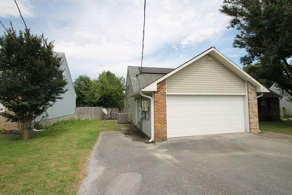 116 Nicole Ln, Crestview, FL 32539 - view of front facade with driveway, a garage, and brick siding