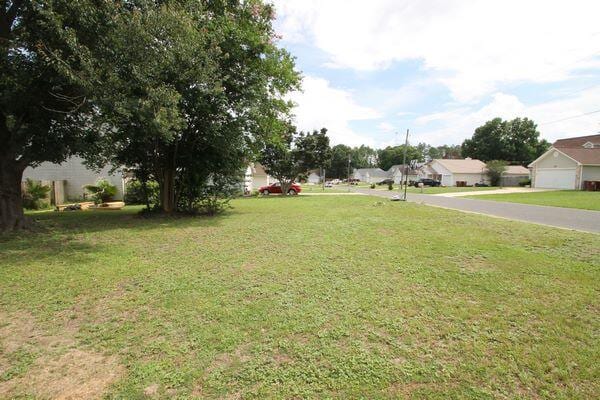 116 Nicole Ln, Crestview, FL 32539 - view of green lawn featuring a garage and a residential view