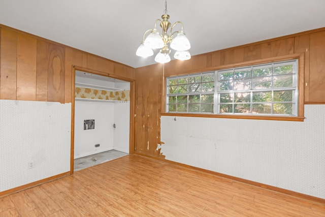19 Bayview Dr, Shalimar, FL 32579 - unfurnished room with a chandelier, wood finished floors, and healthy amount of natural light