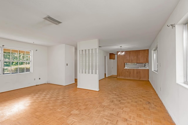 19 Bayview Dr, Shalimar, FL 32579 - unfurnished living room featuring a chandelier and baseboards