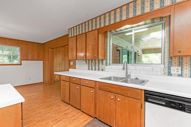 19 Bayview Dr, Shalimar, FL 32579 - kitchen with white dishwasher, light countertops, light wood-style flooring, backsplash, and brown cabinets