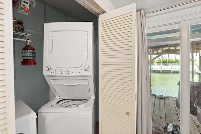 113 Durango Rd, Destin, FL 32541 - laundry room with stacked washer / dryer, a water view, and wood finished floors