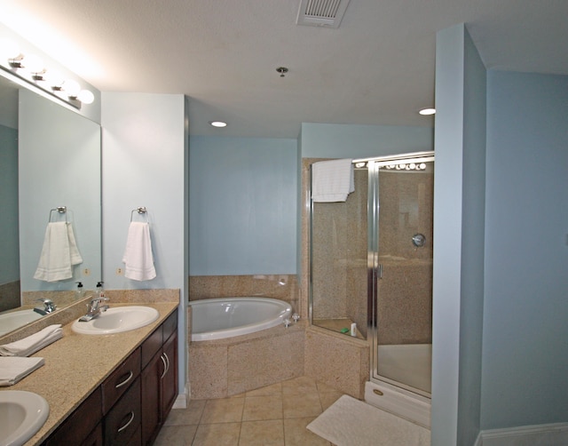 9902 S Thomas Dr Unit 1828, Panama City Beach, FL 32408 - full bathroom featuring a bath, double vanity, tile patterned flooring, a stall shower, and recessed lighting