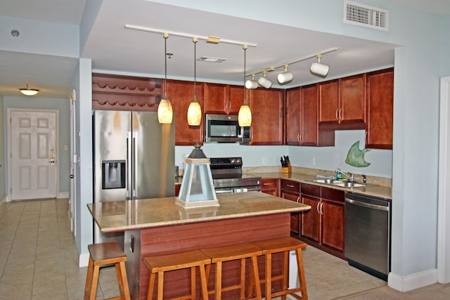 9902 S Thomas Dr Unit 1828, Panama City Beach, FL 32408 - kitchen with appliances with stainless steel finishes, a sink, light stone counters, a kitchen island, and a kitchen breakfast bar