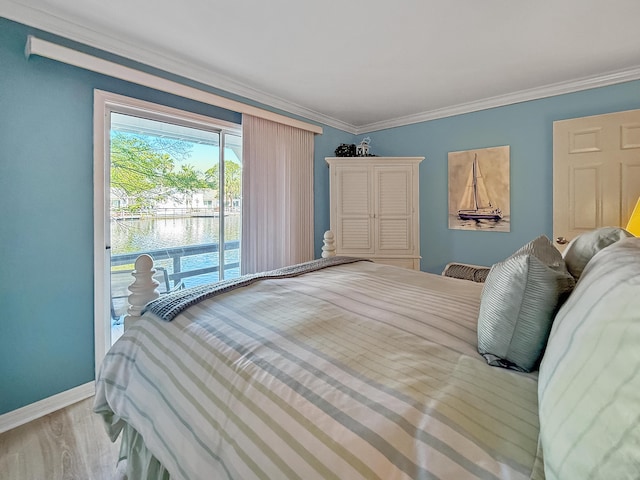 458 Linkside Pl, Miramar Beach, FL 32550 - bedroom featuring access to exterior, a water view, wood finished floors, baseboards, and crown molding