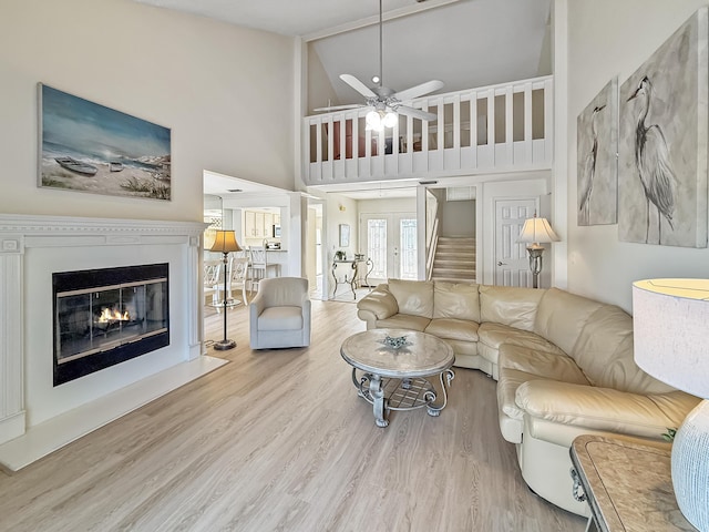458 Linkside Pl, Miramar Beach, FL 32550 - living room with a ceiling fan, wood finished floors, a fireplace with flush hearth, and high vaulted ceiling