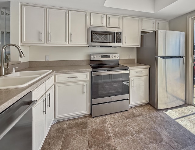 458 Linkside Pl, Miramar Beach, FL 32550 - kitchen with appliances with stainless steel finishes, a sink, and white cabinetry