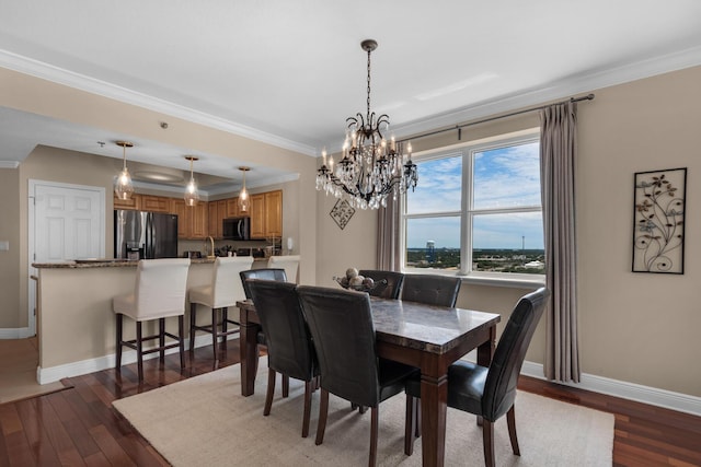 112 Seascape Dr Unit 1201, Miramar Beach, FL 32550 - dining area with baseboards, a chandelier, ornamental molding, and dark wood-style flooring