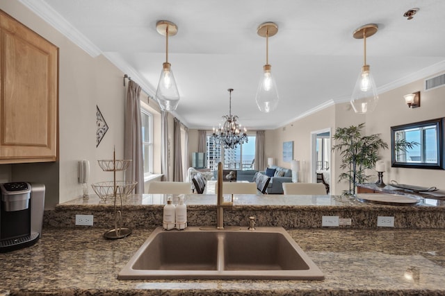 112 Seascape Dr Unit 1201, Miramar Beach, FL 32550 - kitchen featuring light brown cabinetry, open floor plan, a chandelier, crown molding, and decorative light fixtures