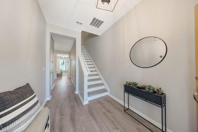 233 Sand Oak Blvd, Panama City Beach, FL 32413 - hallway with light wood finished floors, stairs, and baseboards