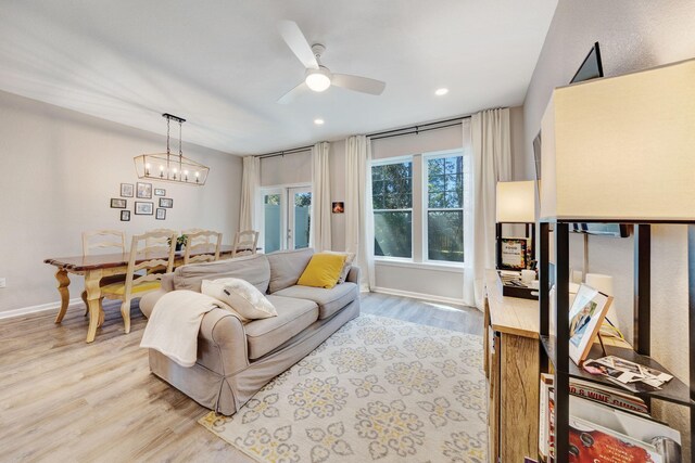 233 Sand Oak Blvd, Panama City Beach, FL 32413 - living room with light wood-style flooring, ceiling fan, baseboards, recessed lighting, and a chandelier