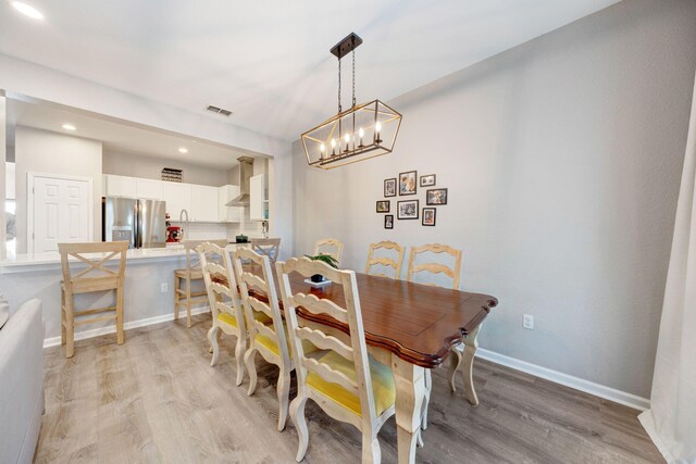 233 Sand Oak Blvd, Panama City Beach, FL 32413 - dining space featuring light wood-style flooring, a chandelier, recessed lighting, and baseboards