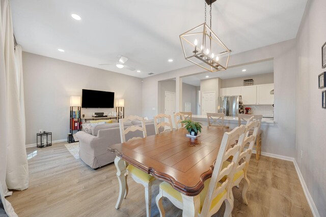 233 Sand Oak Blvd, Panama City Beach, FL 32413 - dining area with light wood-style flooring, baseboards, a chandelier, recessed lighting, and a ceiling fan