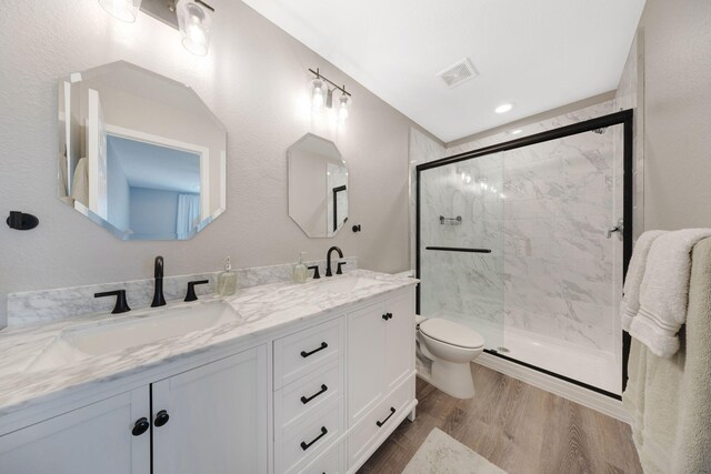 233 Sand Oak Blvd, Panama City Beach, FL 32413 - full bathroom with toilet, double vanity, wood finished floors, and a marble finish shower