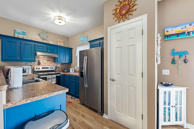 6922 Sea Turtle Cir, Navarre, FL 32566 - kitchen featuring appliances with stainless steel finishes, blue cabinets, light wood-style floors, and under cabinet range hood