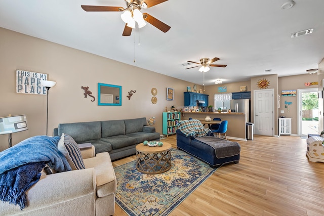 6922 Sea Turtle Cir, Navarre, FL 32566 - living room featuring ceiling fan and light wood finished floors