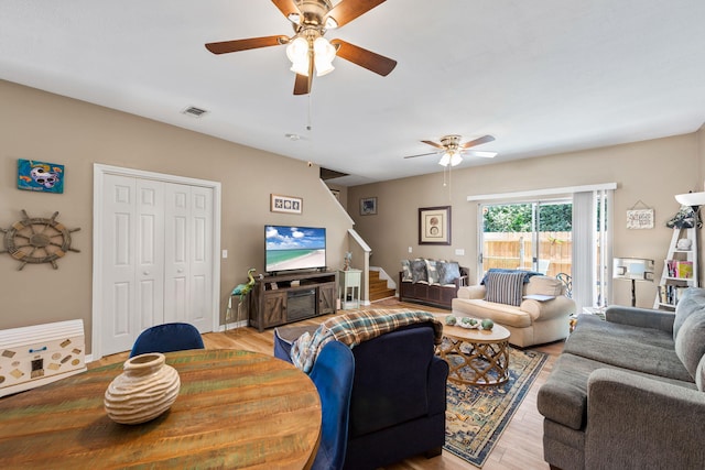 6922 Sea Turtle Cir, Navarre, FL 32566 - living area featuring ceiling fan, wood finished floors, and stairs