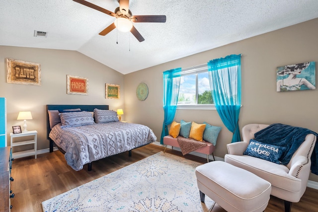 6922 Sea Turtle Cir, Navarre, FL 32566 - bedroom featuring wood finished floors, a ceiling fan, a textured ceiling, vaulted ceiling, and baseboards