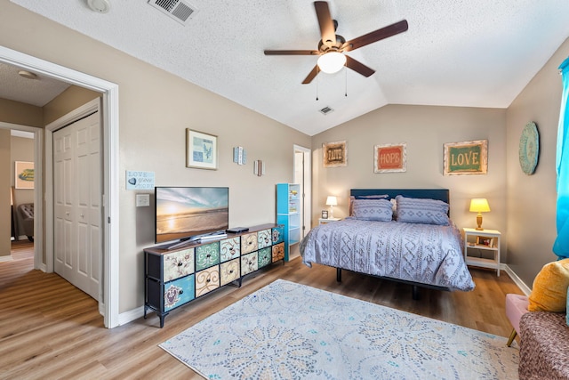 6922 Sea Turtle Cir, Navarre, FL 32566 - bedroom with wood finished floors, vaulted ceiling, ceiling fan, and a textured ceiling