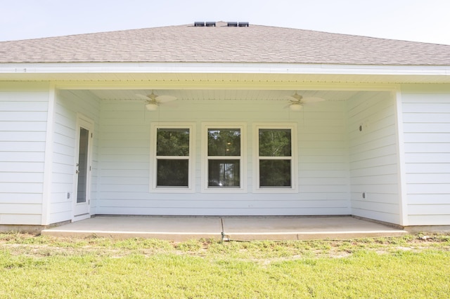 56 Secluded Cir, Freeport, FL 32439 - rear view of property featuring ceiling fan, a patio area, a lawn, and roof with shingles