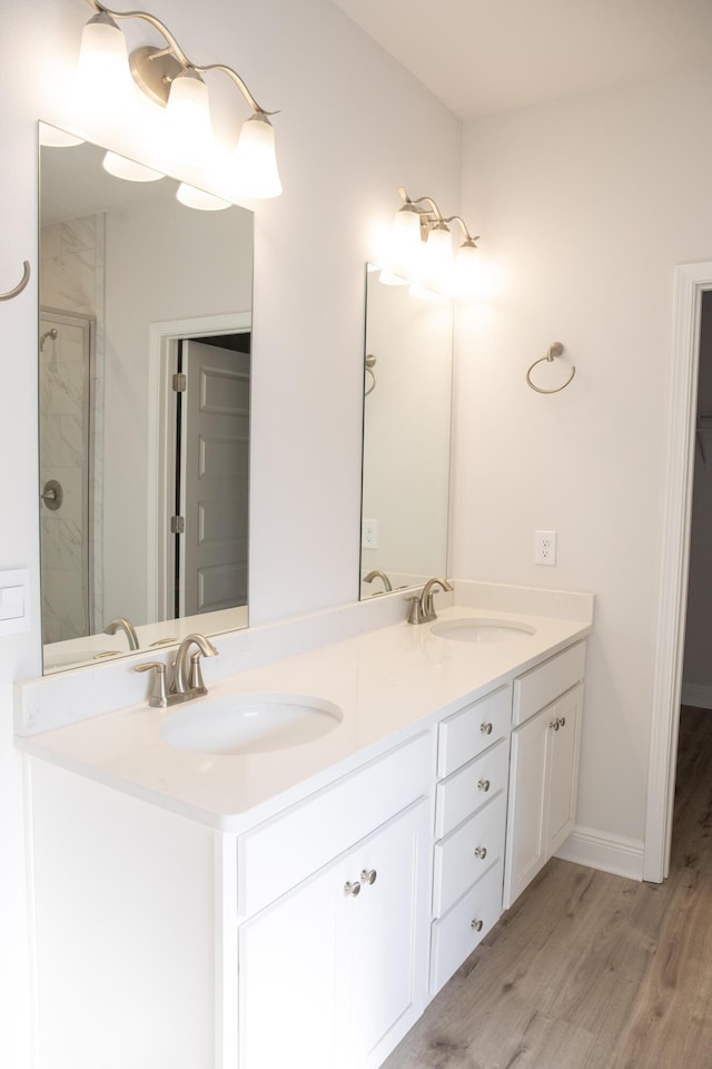 56 Secluded Cir, Freeport, FL 32439 - bathroom with double vanity, wood finished floors, and a stall shower