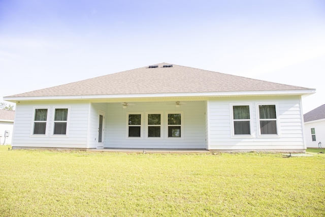 56 Secluded Cir, Freeport, FL 32439 - rear view of house with ceiling fan, a yard, and roof with shingles