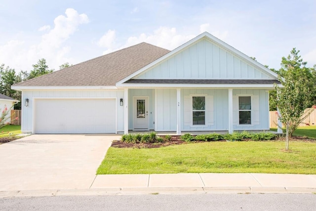 56 Secluded Cir, Freeport, FL 32439 - modern farmhouse style home featuring board and batten siding, an attached garage, concrete driveway, a shingled roof, and covered porch