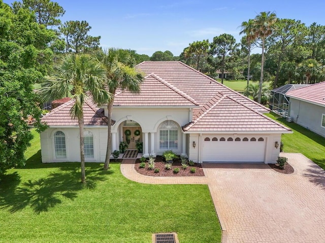 527 Indigo Loop, Miramar Beach, FL 32550 - mediterranean / spanish home featuring french doors, a tiled roof, an attached garage, decorative driveway, and a front yard