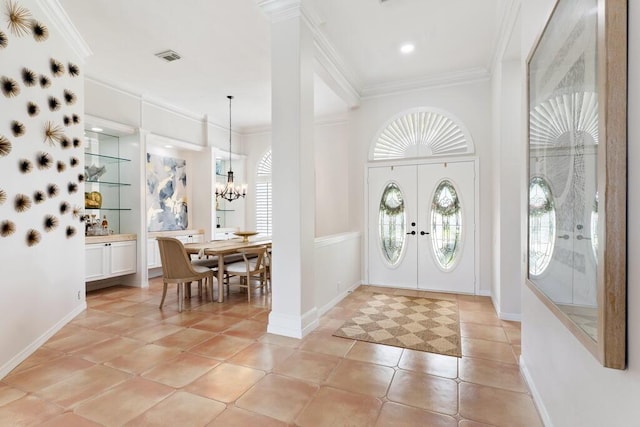 527 Indigo Loop, Miramar Beach, FL 32550 - entryway featuring plenty of natural light, ornamental molding, a chandelier, french doors, and light tile patterned floors