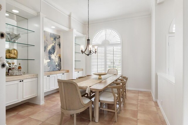 527 Indigo Loop, Miramar Beach, FL 32550 - dining space featuring ornamental molding, a chandelier, light tile patterned flooring, and baseboards