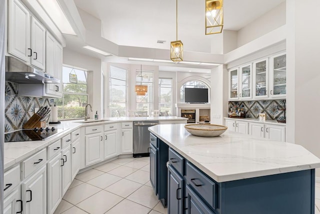 527 Indigo Loop, Miramar Beach, FL 32550 - kitchen featuring dishwasher, a sink, a center island, white cabinets, and decorative backsplash
