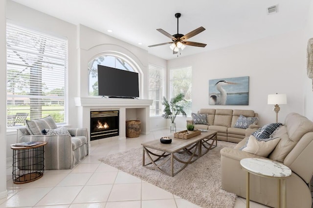 527 Indigo Loop, Miramar Beach, FL 32550 - living room featuring a ceiling fan, tile patterned floors, a lit fireplace, baseboards, and recessed lighting