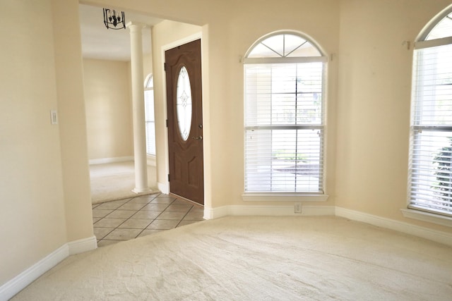 222 Wekiva Cv, Destin, FL 32541 - entrance foyer with carpet, baseboards, tile patterned floors, and decorative columns