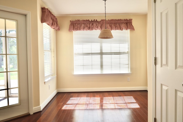 222 Wekiva Cv, Destin, FL 32541 - unfurnished dining area featuring dark wood-style flooring and baseboards