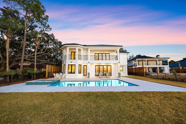 253 Driftwood Point Rd, Santa Rosa Beach, FL 32459 - rear view of house featuring a balcony, a patio, a pool with connected hot tub, and stucco siding