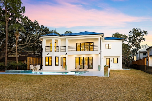 253 Driftwood Point Rd, Santa Rosa Beach, FL 32459 - back of house with a balcony, stucco siding, a patio area, and metal roof