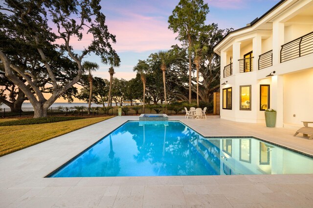 253 Driftwood Point Rd, Santa Rosa Beach, FL 32459 - pool at dusk featuring a patio area and a pool with connected hot tub