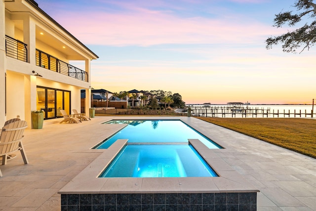 253 Driftwood Point Rd, Santa Rosa Beach, FL 32459 - pool at dusk featuring a water view, a patio, and a pool with connected hot tub