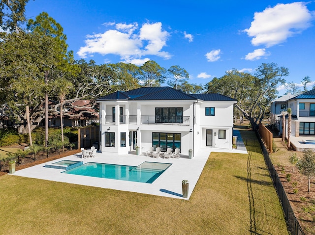 253 Driftwood Point Rd, Santa Rosa Beach, FL 32459 - back of house featuring a balcony, stucco siding, a patio area, outdoor lounge area, and a standing seam roof