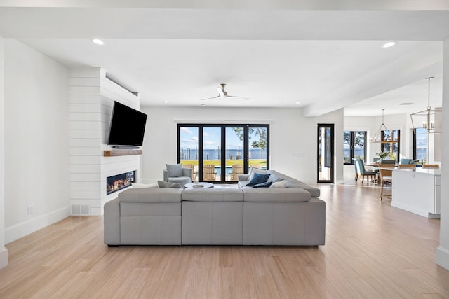 253 Driftwood Point Rd, Santa Rosa Beach, FL 32459 - living area featuring light wood-type flooring, a large fireplace, recessed lighting, baseboards, and a chandelier