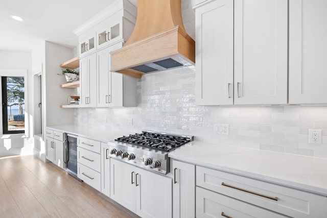 253 Driftwood Point Rd, Santa Rosa Beach, FL 32459 - kitchen featuring premium range hood, stainless steel gas stovetop, wine cooler, open shelves, and white cabinets