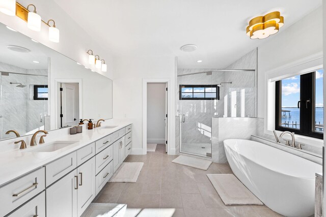 253 Driftwood Point Rd, Santa Rosa Beach, FL 32459 - full bathroom featuring double vanity, a stall shower, a soaking tub, and tile patterned flooring
