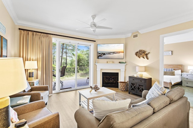 1653 W County Highway 30a Unit 1119, Santa Rosa Beach, FL 32459 - living area with crown molding, a ceiling fan, light wood-type flooring, and a fireplace