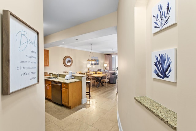 1653 W County Highway 30a Unit 1119, Santa Rosa Beach, FL 32459 - kitchen featuring dishwasher, brown cabinets, a breakfast bar area, open floor plan, and light stone countertops