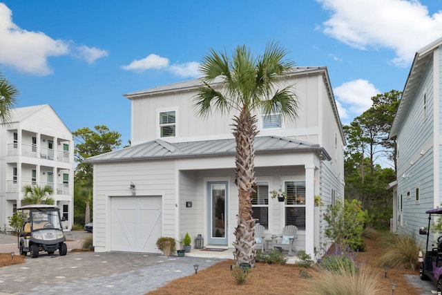 38 Constant Ave, Santa Rosa Beach, FL 32459 - view of front of property with a standing seam roof, a garage, driveway, and metal roof
