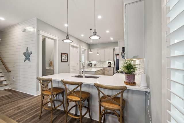 38 Constant Ave, Santa Rosa Beach, FL 32459 - kitchen featuring a sink, light countertops, dark wood-style flooring, decorative backsplash, and hanging light fixtures