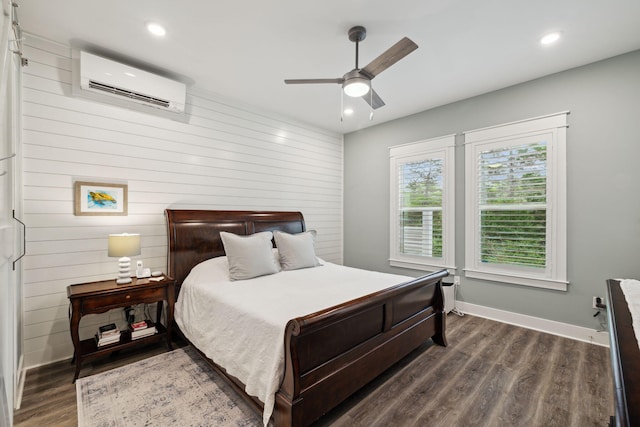 38 Constant Ave, Santa Rosa Beach, FL 32459 - bedroom with a wall unit AC, dark wood-style flooring, baseboards, recessed lighting, and wooden walls
