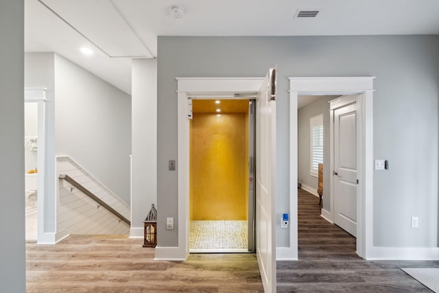 38 Constant Ave, Santa Rosa Beach, FL 32459 - corridor with an upstairs landing, elevator, wood finished floors, baseboards, and recessed lighting